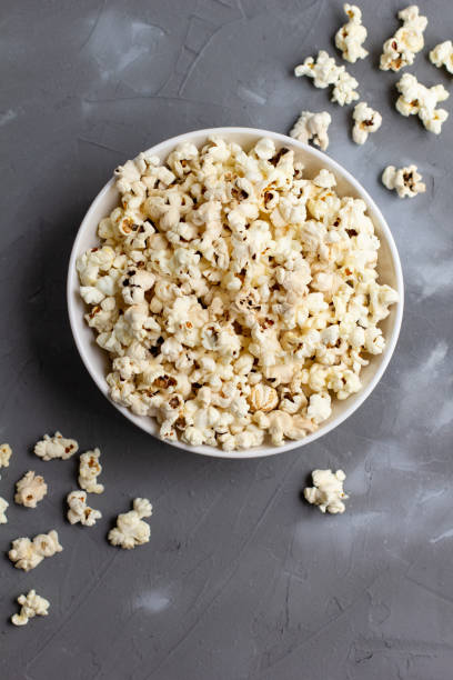 istock Popcorn in white bowl on grey table. Top view with copyspace 1272931819