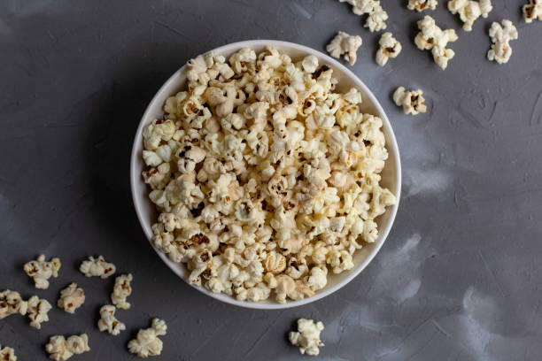 istock Popcorn in white bowl on grey table. Top view with copyspace 1272931828