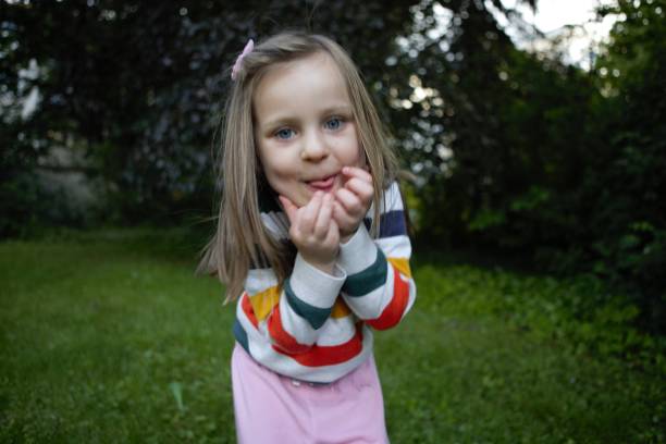istock Little girl pulling funny faces in the park 1272935740