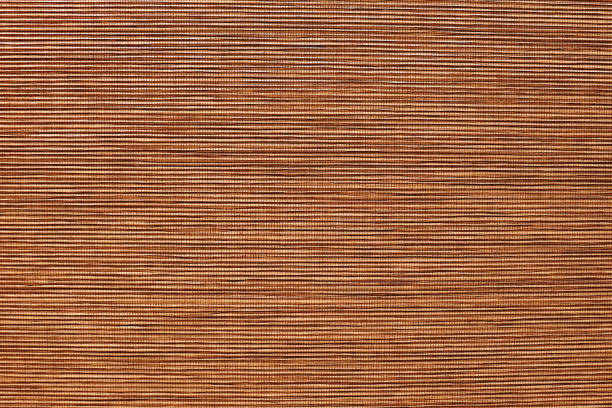 istock Bamboo mat closeup. Thin strips of wood sewn into fabric 1272935961