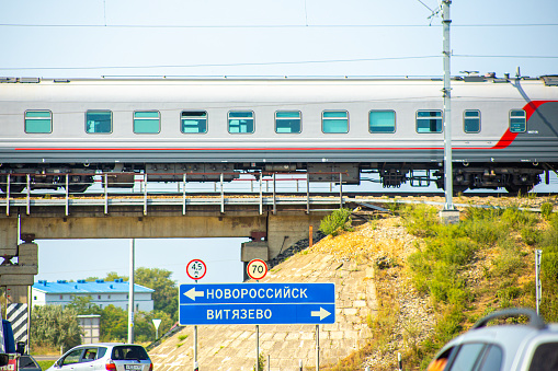 Anapa, Russia-08.21.2019: A fast train over the road goes along the railway line, the Novorossiysk-Vityazevo route-translation of the sign