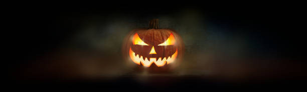 One spooky evil halloween lantern, Jack O Lantern, with glowing eyes and face