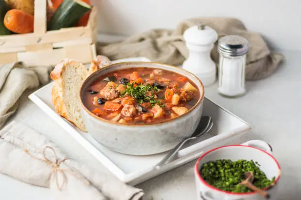 Traditional Italian Chicken Stew Stew Soup in bright vibrant kitchen setting with food styling look