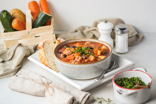 Traditional Italian Chicken Stew Stew Soup in bright vibrant kitchen setting with food styling look