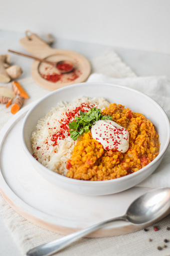 Indian Dhal Curry with Chili and Rice in bright vibrant kitchen setting with food styling look