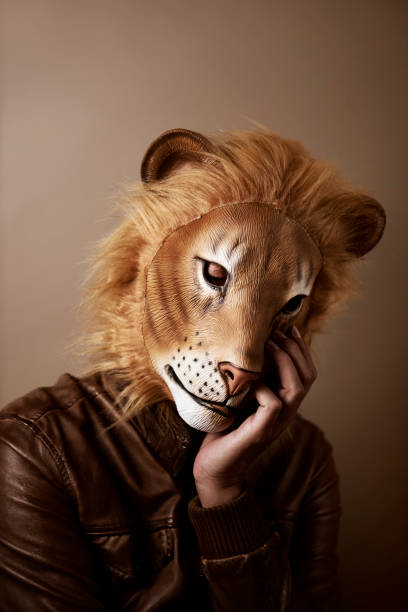 istock man wearing a lion mask, retro 1272938693