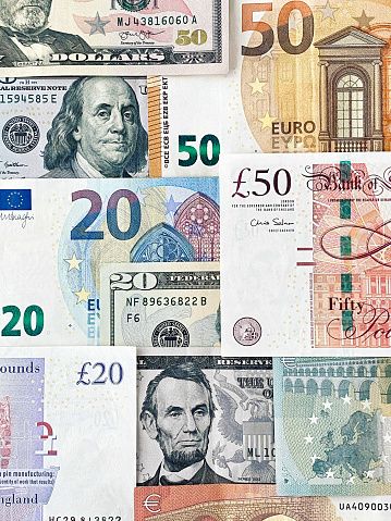 Looking down on flat laid Dollar and Euro banknotes