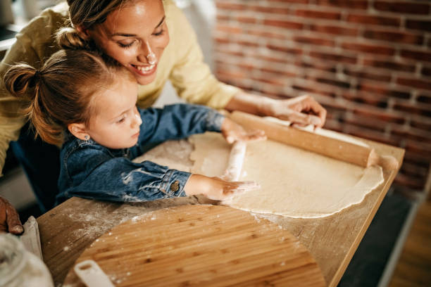 istock Mother and daughter making pizza at home 1272939989