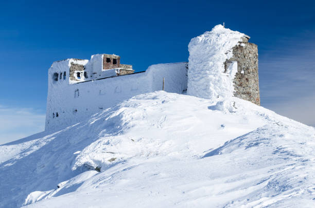 Winter view of abandoned observatory atop the mountain Pip Ivan in Ukrainian Carpathians. It goes through the process of reconstruction now