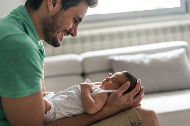 istock Father holding newborn baby 1272943604