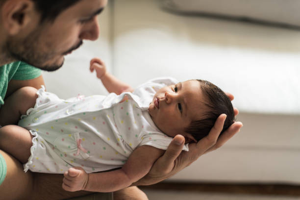 istock Father holding newborn baby 1272943714