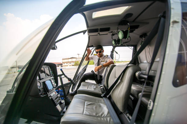 istock Portrait Of Pilot Sitting In Helicopter 1272943786