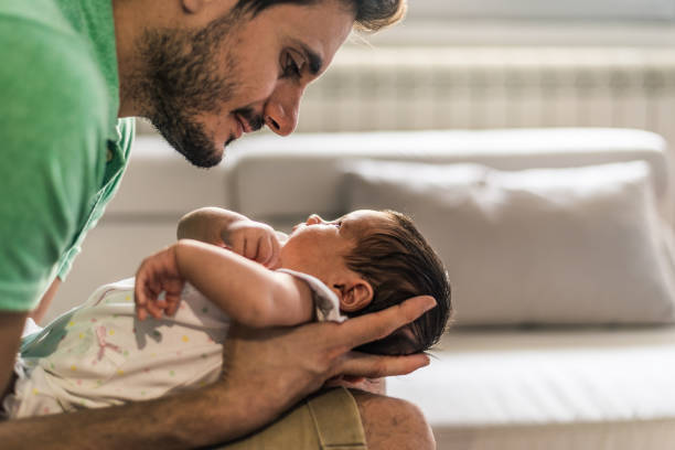 istock Father holding newborn baby 1272944119