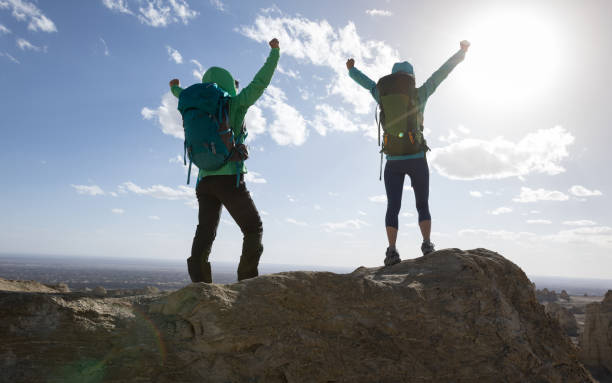 istock Two women backpackers hiking on sand desert dunes 1272946155