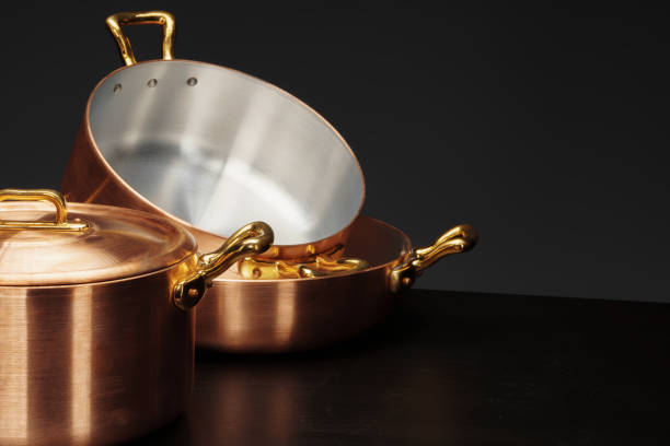 Set of copper cookware over dark background. High quality photo