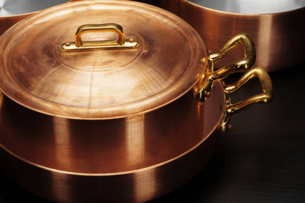 istock Shiny vintage copper cookware over dark background 1272946355