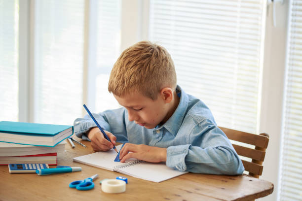 istock Teenage boy drawing lines with a help of ruler 1272947548