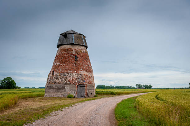 istock Rural road leading through the fields to the abandoned windmill 1272947937