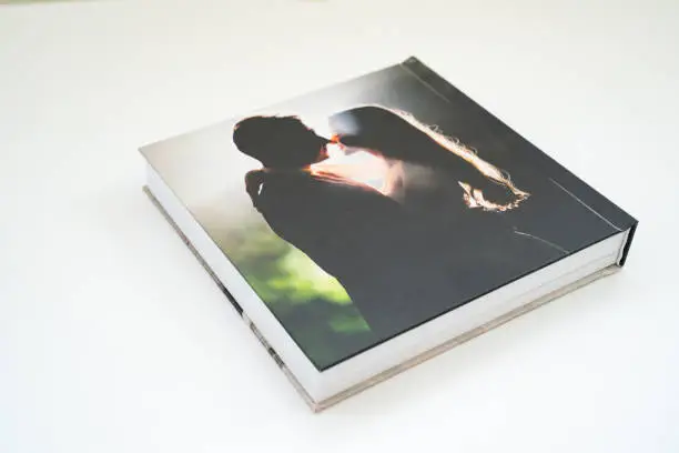 Photo of closed wedding photobook with thick pages