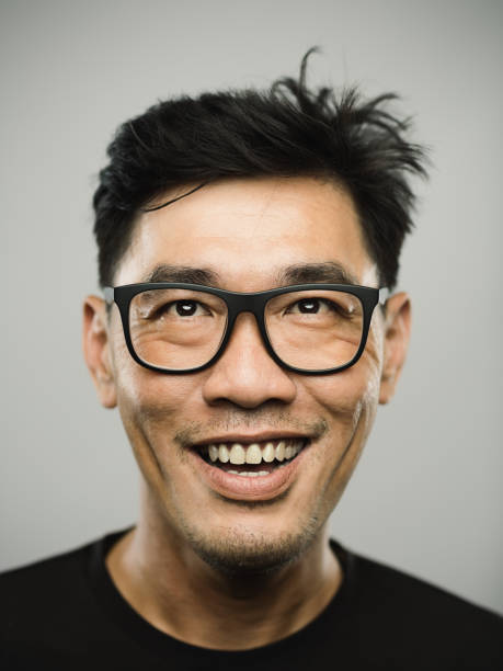 istock Portrait of a real chinese man with happy expression looking up 1272948321