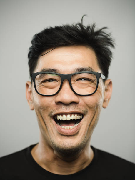 portrait of a real chinese man with excited expression - human face chinese ethnicity close up men imagens e fotografias de stock