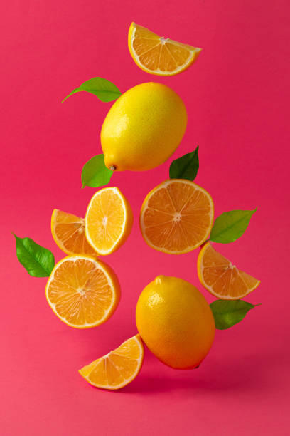 istock Lemons hovering in the air against bright pink background 1272949673