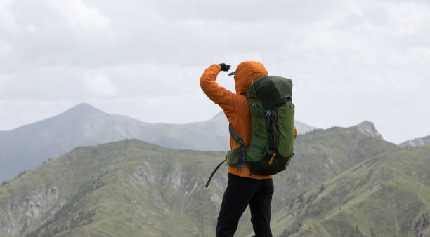 istock Backpacker hiking on high altitude mountain top 1272950399