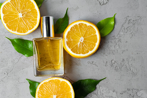 Beautiful composition with bottle of perfume and citrus fruits. High quality photo