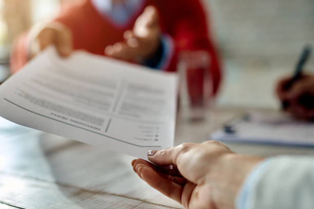 istock Close-up of a candidate giving his CV while applying for a job. 1272953983