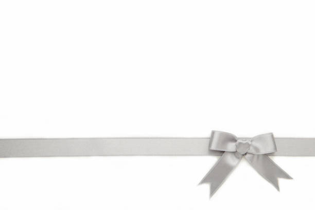 istock Silver ribbon and bow isolated on white background. 1272954250