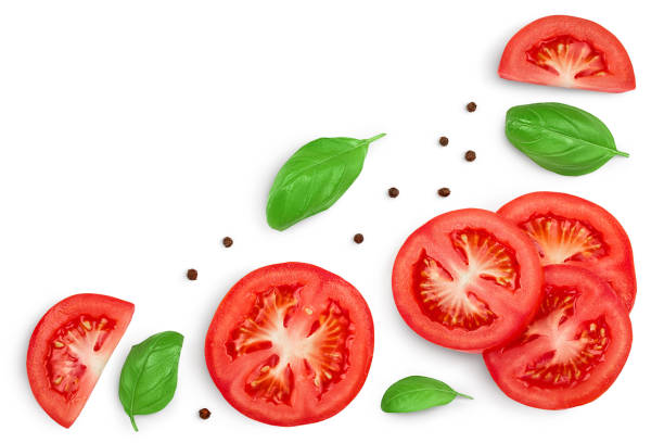 istock Tomato slices with basil and peppercorns isolated on white background. Clipping path. Top view with copy space for your text. Flat lay 1272955750