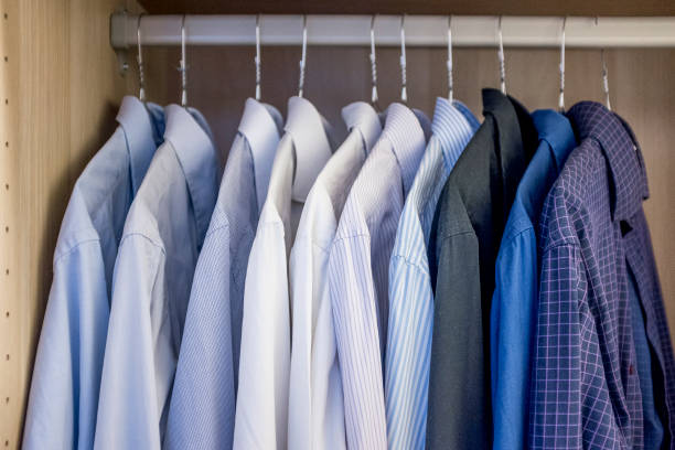 istock men's shirts hanging in a closet 1272960851