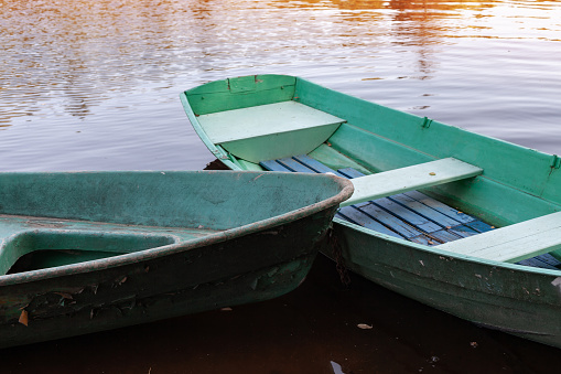 Rowboats are at coast of a still lake