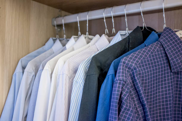 istock men's shirts hanging in a closet 1272961751