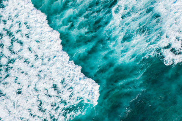 istock Big ocean waves hitting a coral reef. View from above. 1272963766