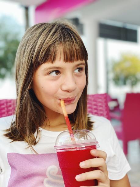istock Girl drinking strawberry slush 1272963836