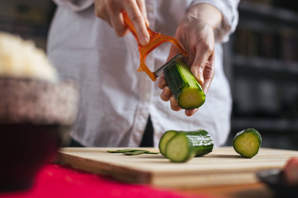 istock Female chef peeling cucumber 1272963845