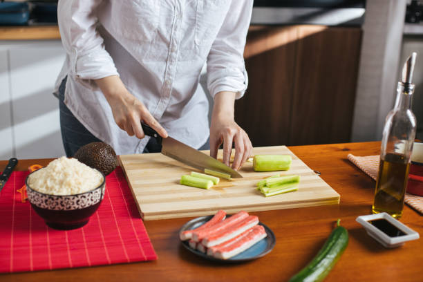 istock Female chef cutting cucumber 1272963874
