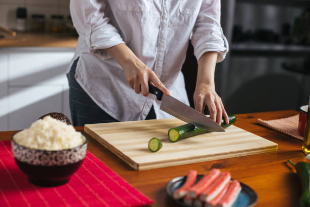 istock Female chef cutting cucumber 1272963875