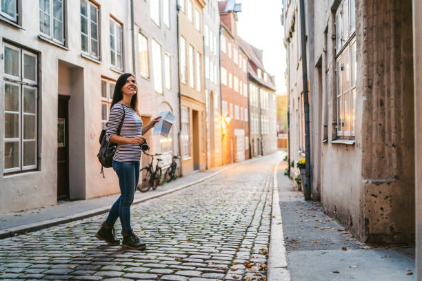 istock Woman exploring Lubeck old town 1272964125