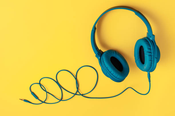 istock Blue headphone on yellow background. Music concept. 1272967256