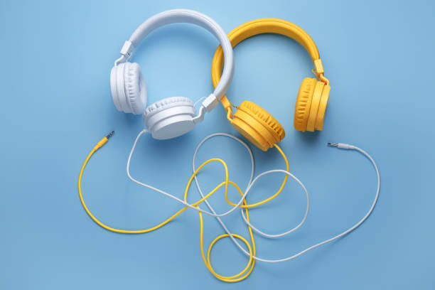 istock Two headphones over blue background. Music concept. 1272967258