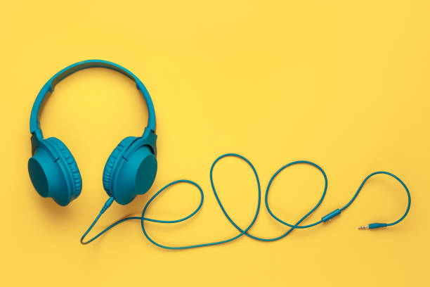 istock Blue headphone on yellow background. Music concept. 1272967269