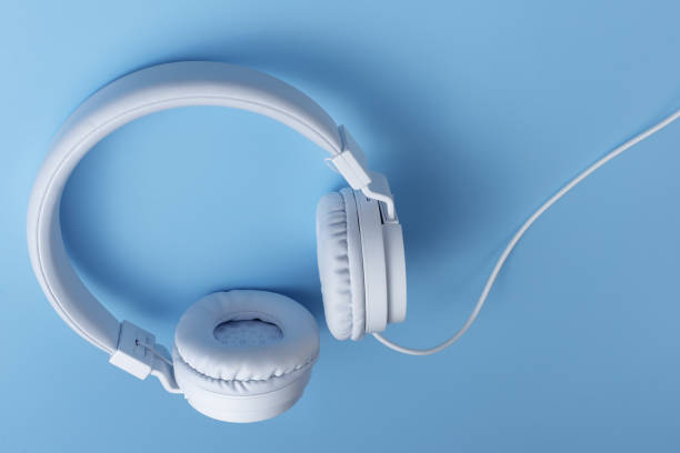 istock White headphone on blue background. Music concept. 1272967289