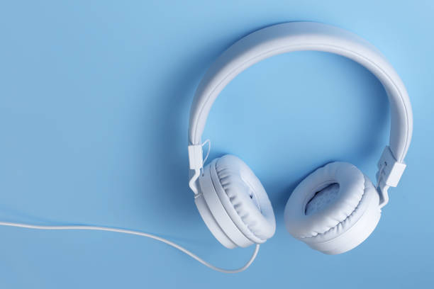 istock Stylish white headphone on blue background. Music concept. 1272967293