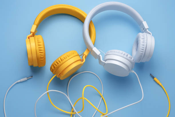 istock Two stylish headphones over blue background. Music concept. 1272967302