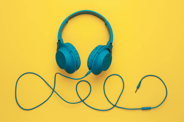 istock Trendy blue headphone on yellow background. Music concept. 1272967305