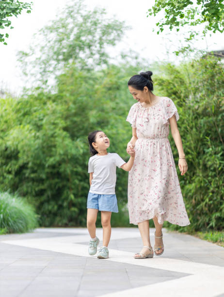 istock Mom and daughter walking and talking 1272969826