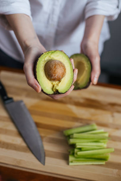 istock Female chef cutting avocado 1272971411