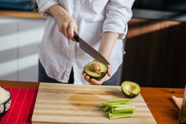 istock Female chef cutting avocado 1272971412